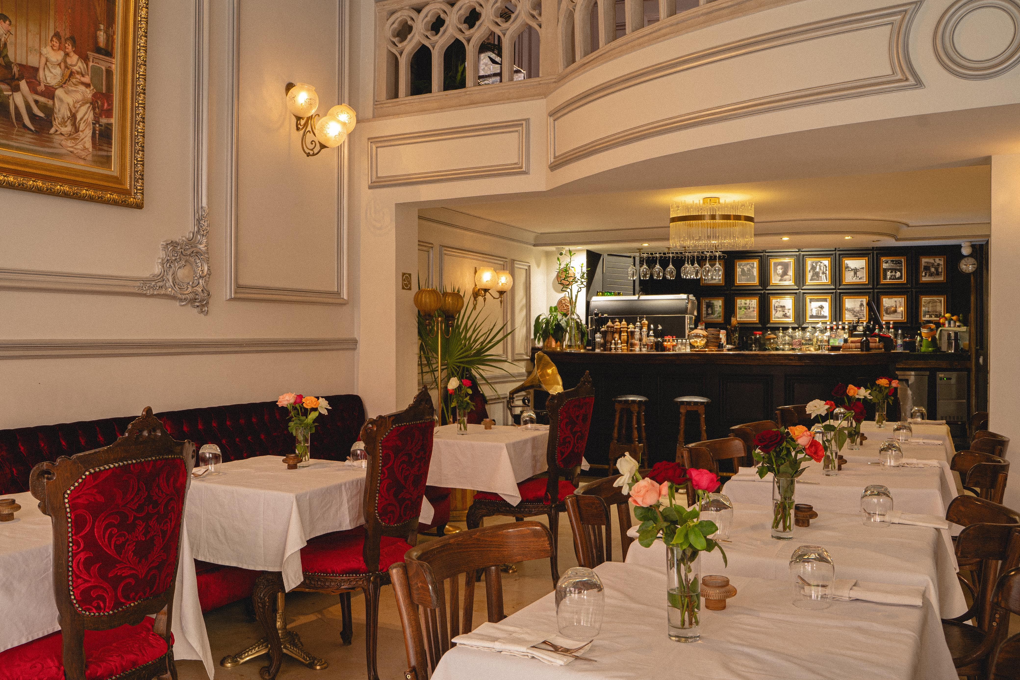 Elegant dining area with white tables and red chairs