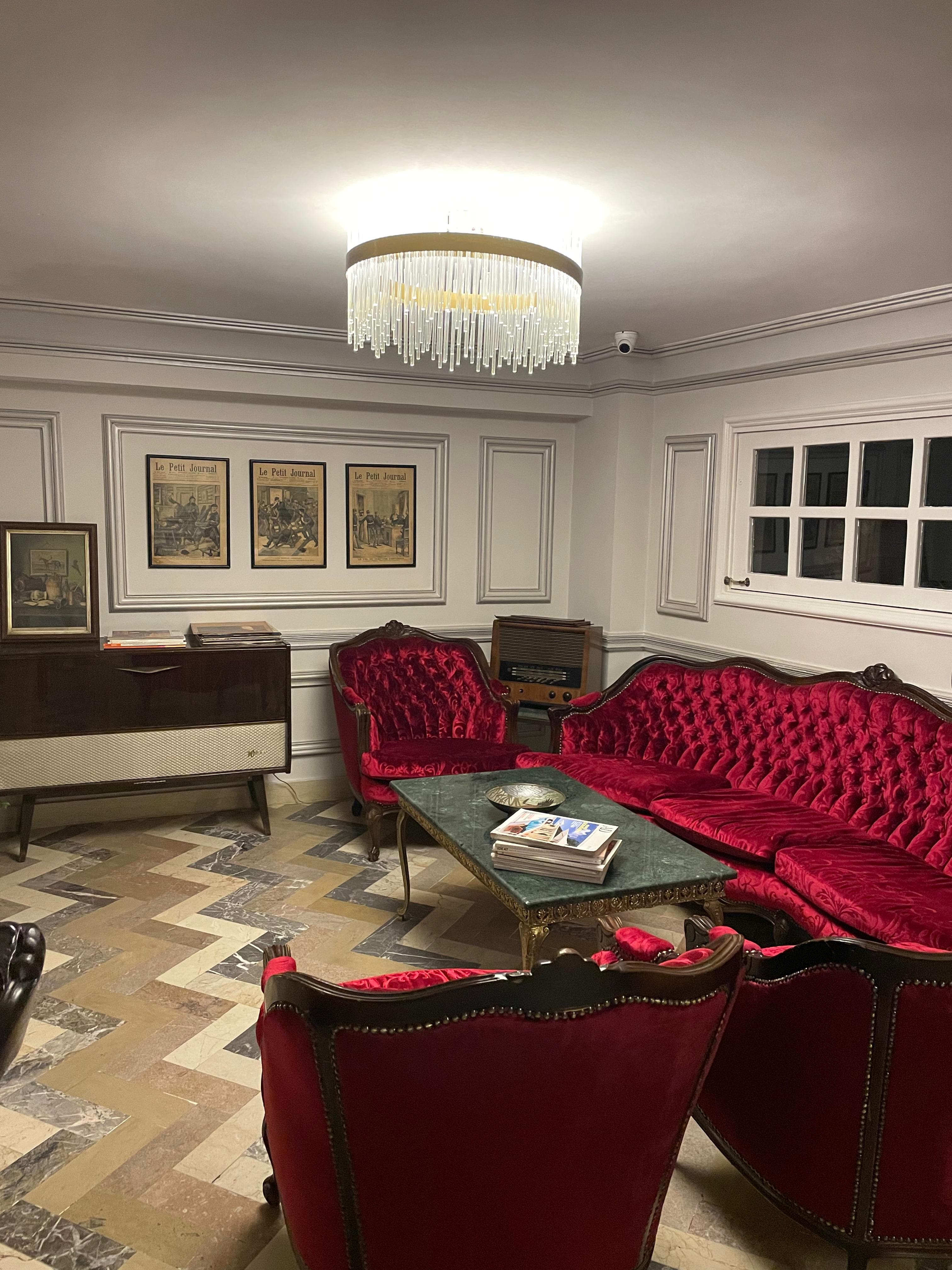 Elegant dining area with white tables and red chairs
