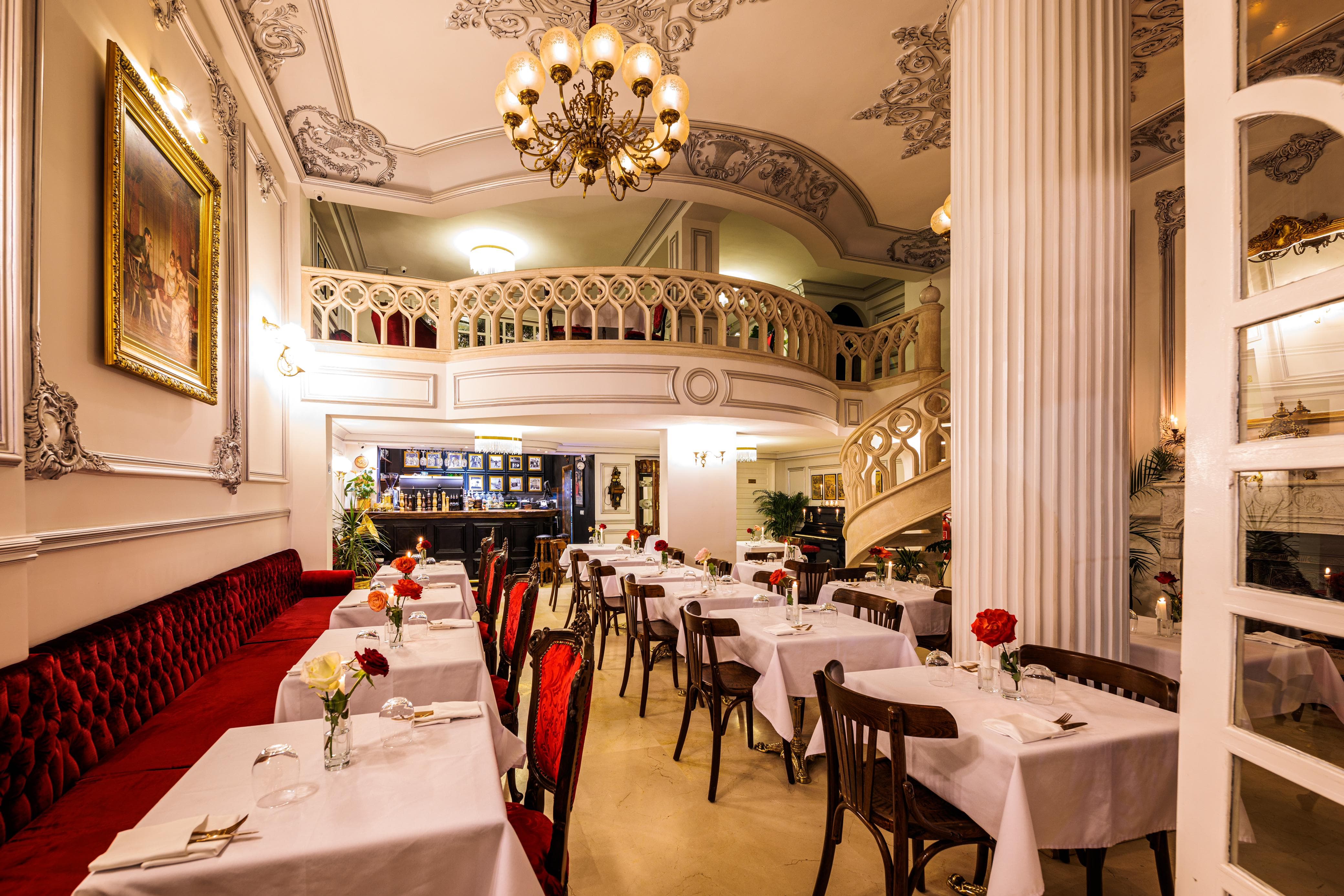 Elegant dining area with white tables and red chairs